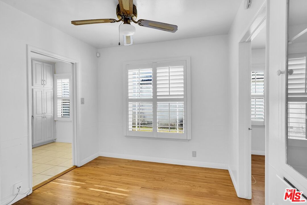 1316 South Castlegate Avenue Compton, CA 90221 - Photo 7 of 28 a view of an empty room with wooden floor and a window