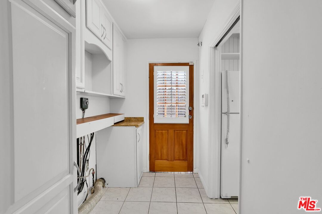 1316 South Castlegate Avenue Compton, CA 90221 - Photo 9 of 28 a view of entryway with cabinet and stairs