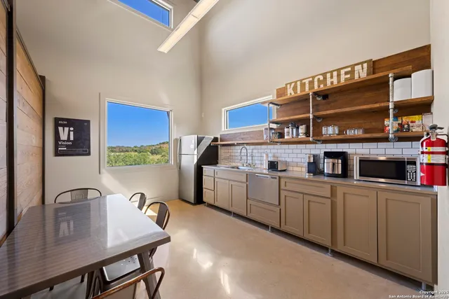a kitchen with stainless steel appliances a sink and a stove