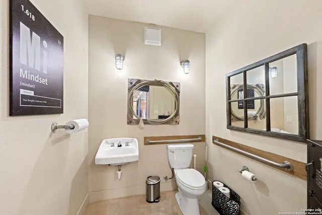 a bathroom with a toilet sink and mirror