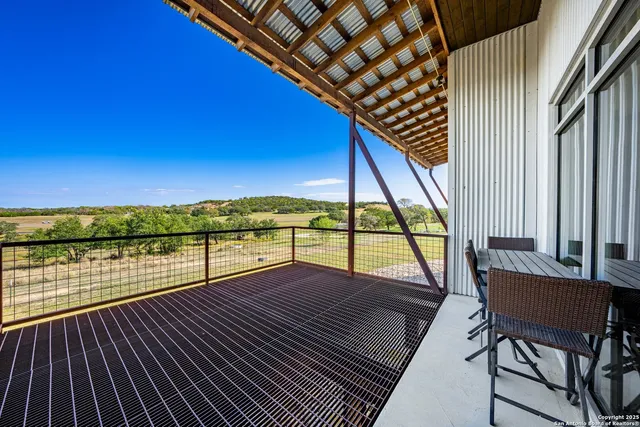 a view of a balcony with lake view and wooden floor