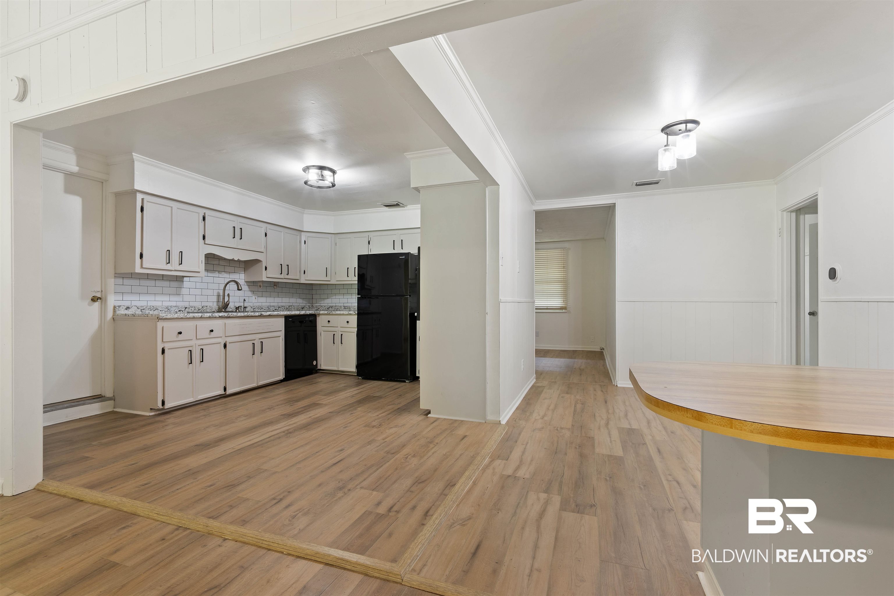 4667 Bit And Spur Road Mobile, AL 36608 - Photo 12 of 27 Kitchen featuring ornamental molding, black appliances, and hardwood / wood-style floors