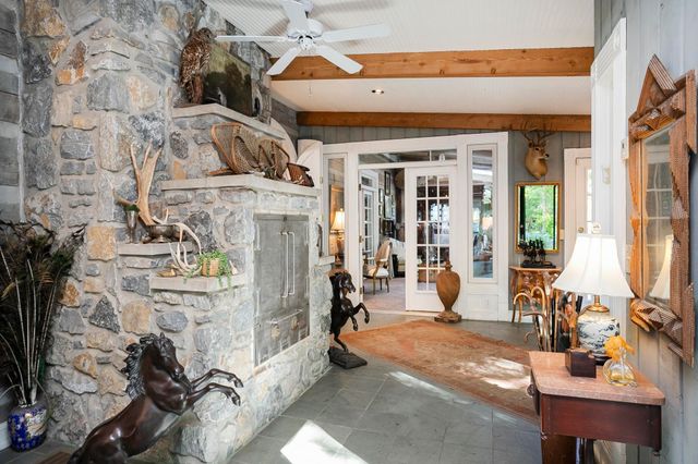 a view of a patio with table and chairs and wooden floor