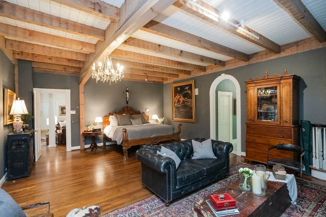 a living room with lots of furniture and a large window