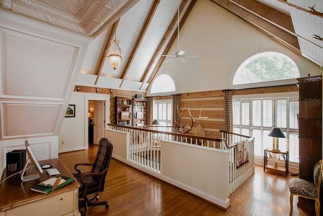 a bedroom with furniture and a large window
