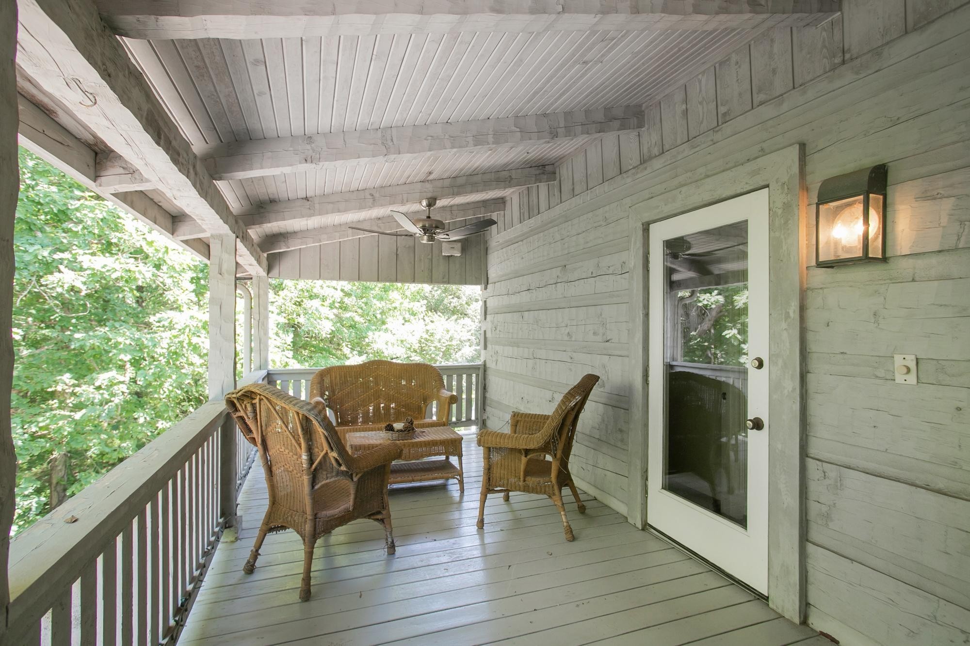 1105 Mt Pleasant Road Kingston Springs, TN 37082 - Photo 49 of 97 a view of a patio with table and chairs and wooden floor