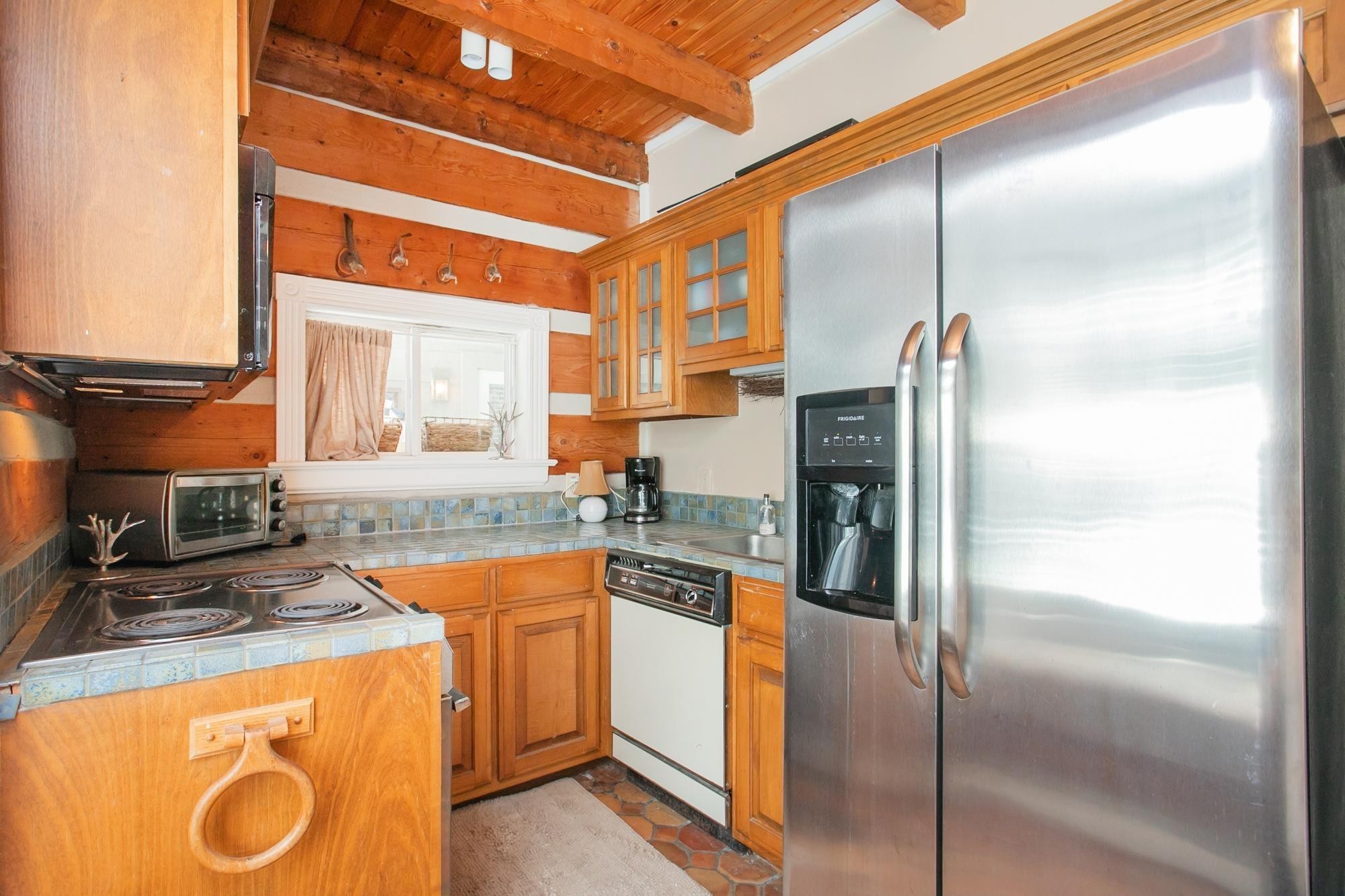 1105 Mt Pleasant Road Kingston Springs, TN 37082 - Photo 74 of 97 a kitchen with a refrigerator and countertop