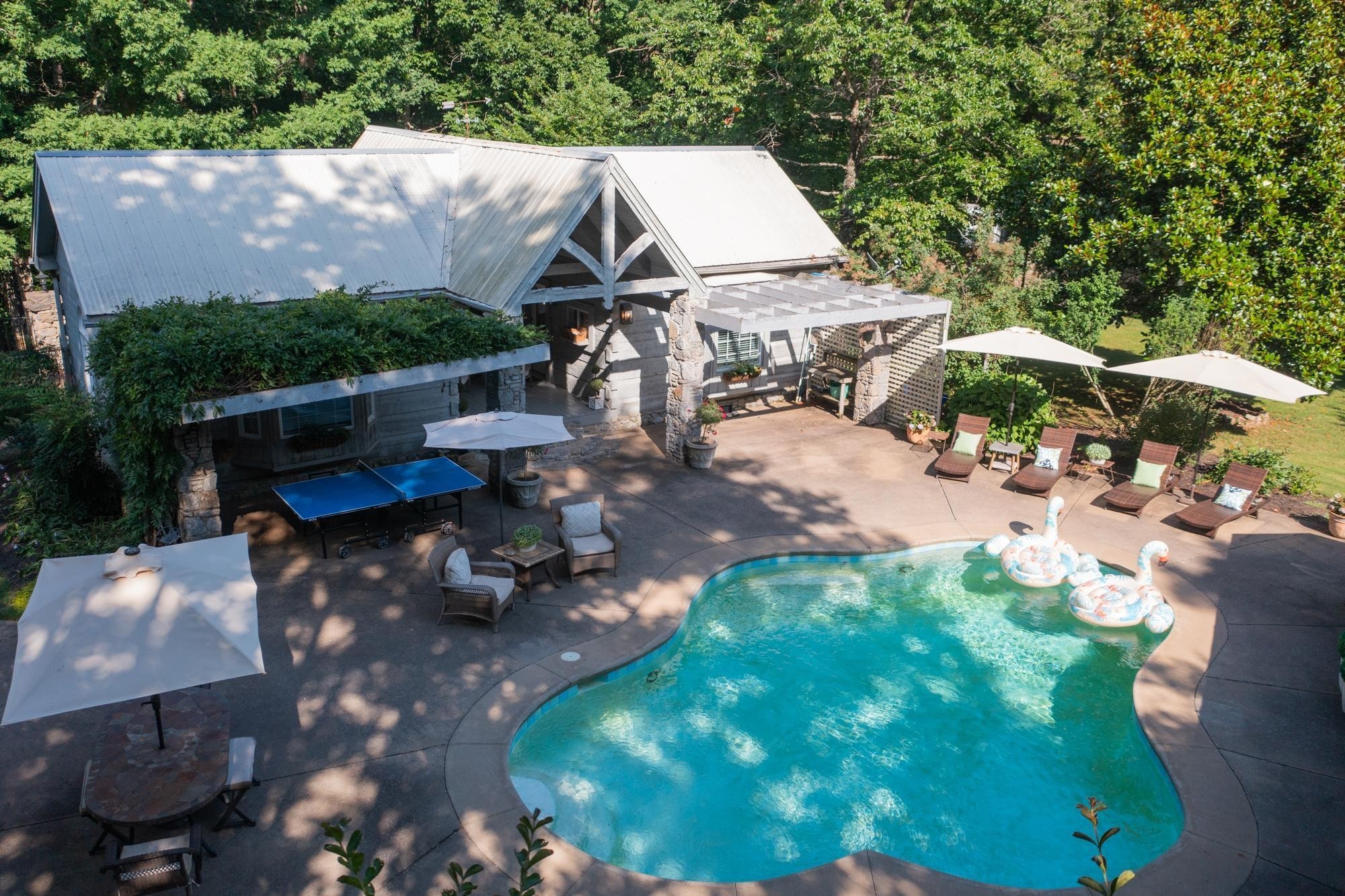 1105 Mt Pleasant Road Kingston Springs, TN 37082 - Photo 89 of 97 a view of a patio with table and chairs potted plants and large tree