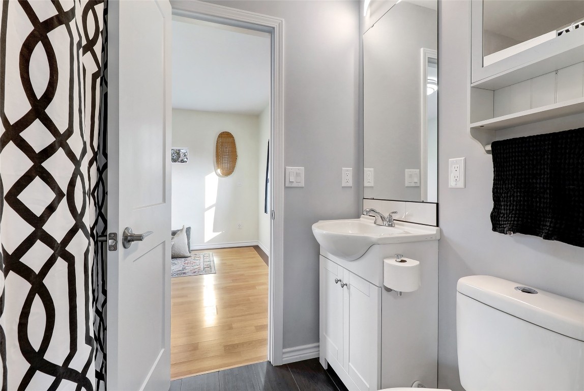 901 Thurman Road San Marcos, TX 78666 - Photo 2 of 32 Bathroom featuring dark wood-style floors, vanity, a shower with shower curtain, and elevator