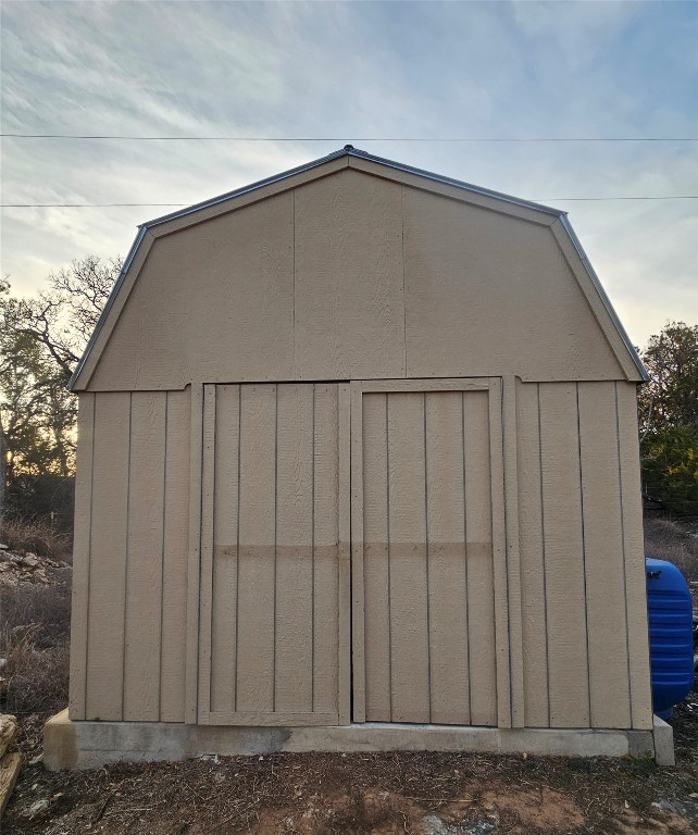 901 Thurman Road San Marcos, TX 78666 - Photo 31 of 32 Outdoor structure at dusk featuring a shed