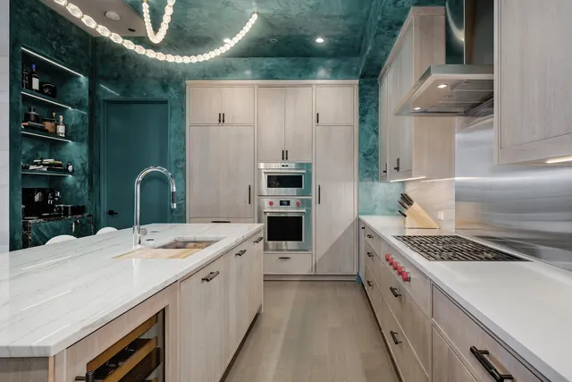 a kitchen that has a lot of cabinets in it