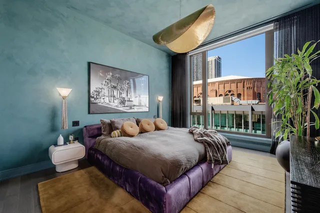 a bedroom with bed and a potted plant