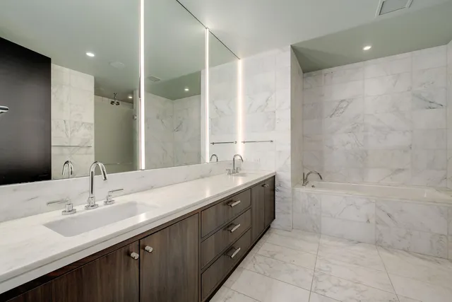 a bathroom with a double vanity sink mirror double and shower
