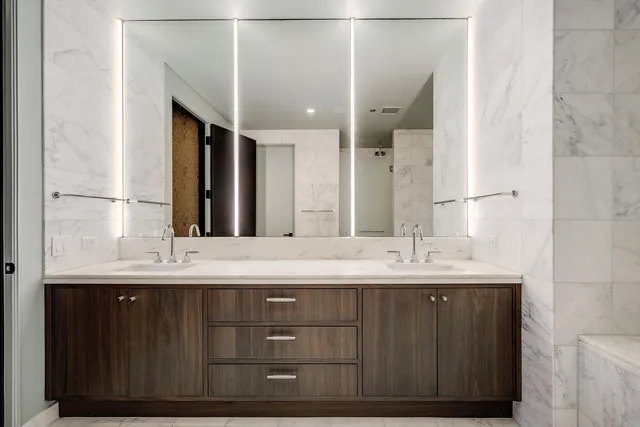 a bathroom with a double vanity sink and a mirror