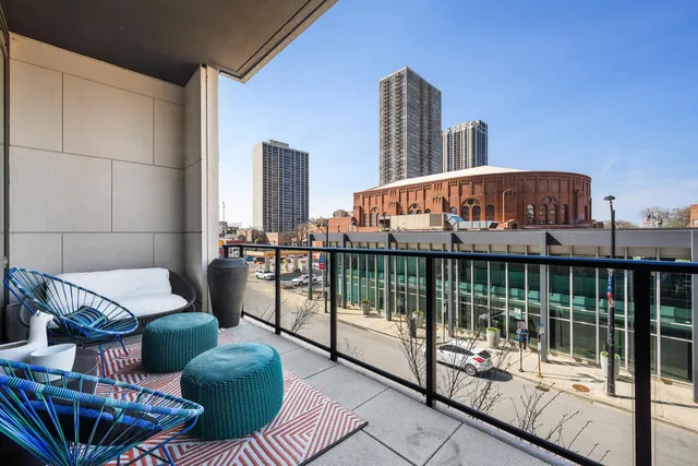 a view of a balcony with two chairs and a potted plant