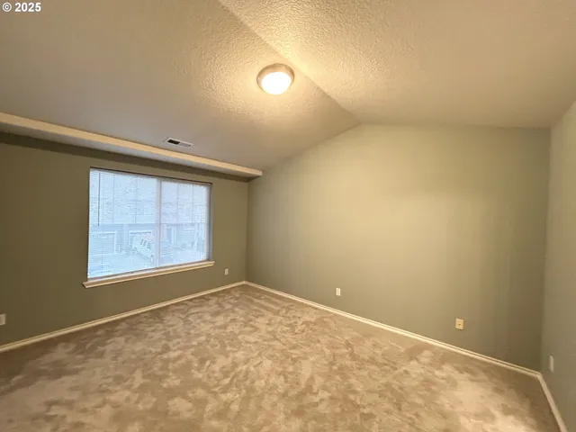 an empty room with a empty space and windows