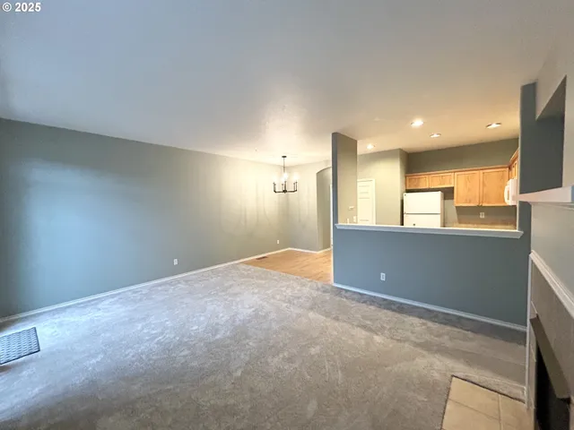 an empty room with a kitchen