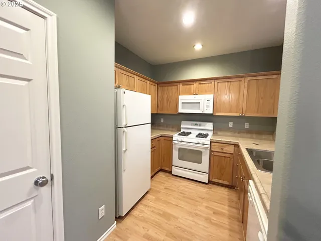 a kitchen with a refrigerator stove and sink