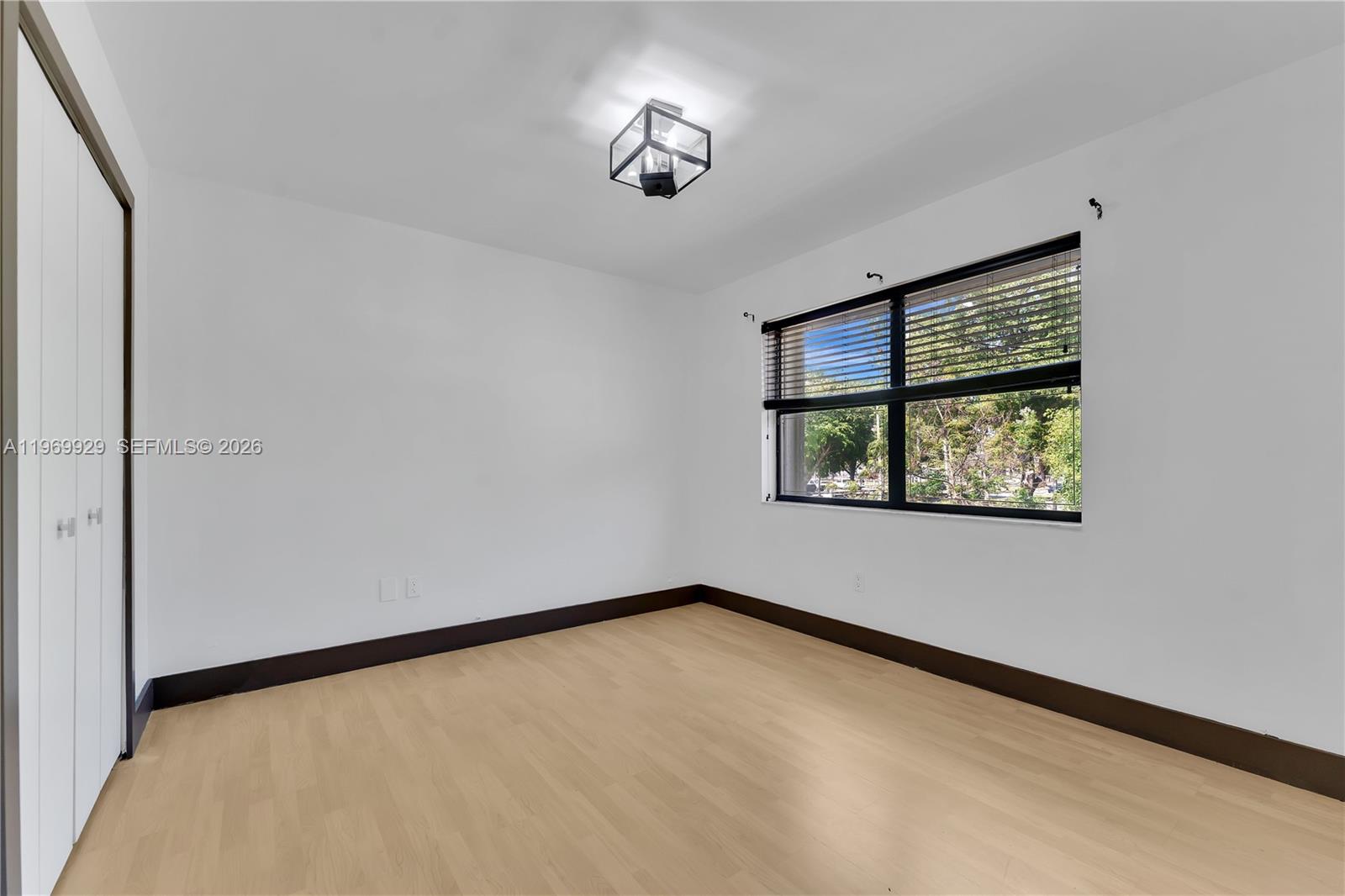 9646 Southwest 151st Avenue, Unit 1 Miami, FL 33196 - Photo 14 of 26 an empty room with a window