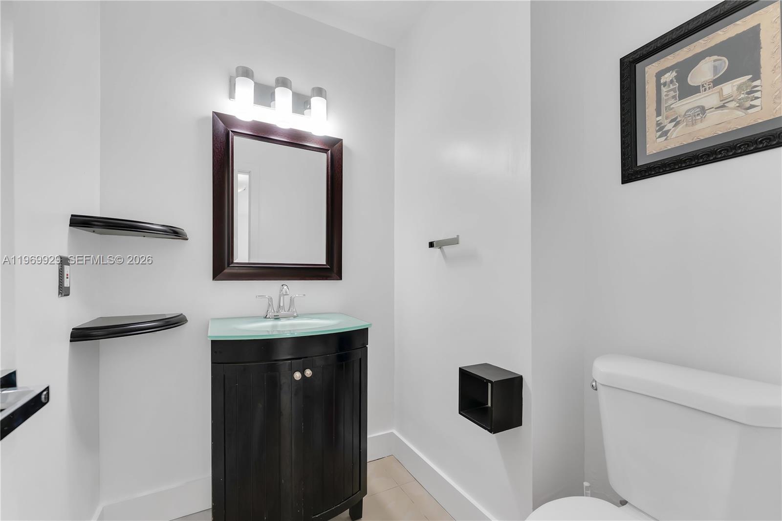 9646 Southwest 151st Avenue, Unit 1 Miami, FL 33196 - Photo 15 of 26 a bathroom with a toilet sink and mirror