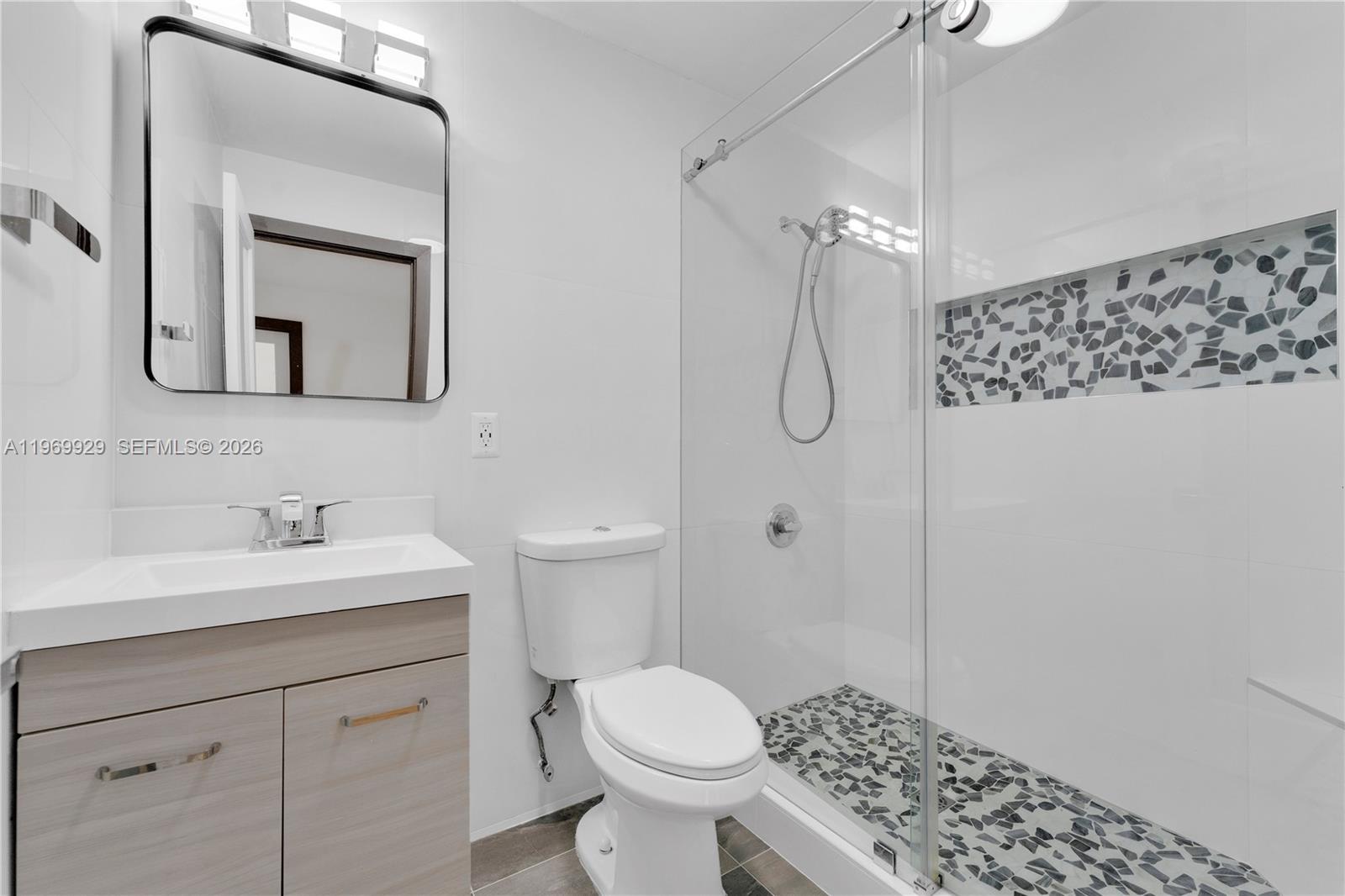 9646 Southwest 151st Avenue, Unit 1 Miami, FL 33196 - Photo 17 of 26 a bathroom with a toilet sink shower and mirror