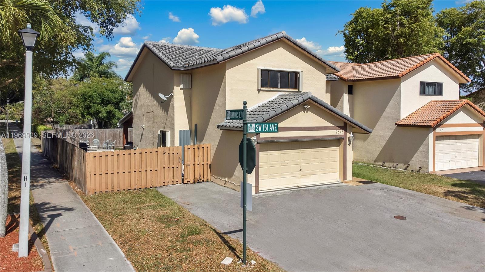 9646 Southwest 151st Avenue, Unit 1 Miami, FL 33196 - Photo 23 of 26 a view of a house with a yard and fence