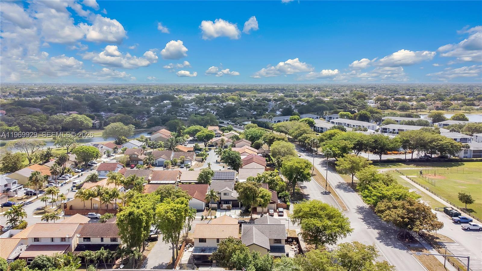9646 Southwest 151st Avenue, Unit 1 Miami, FL 33196 - Photo 25 of 26 a view of a city with lots of residential buildings ocean and mountain view in back