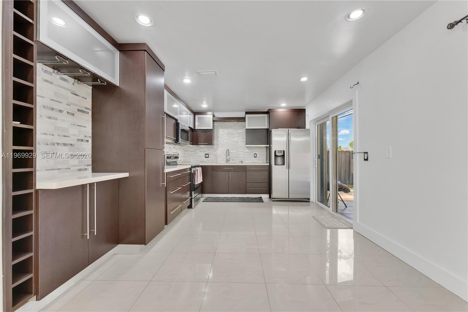 9646 Southwest 151st Avenue, Unit 1 Miami, FL 33196 - Photo 7 of 26 a large white kitchen with a refrigerator and a sink