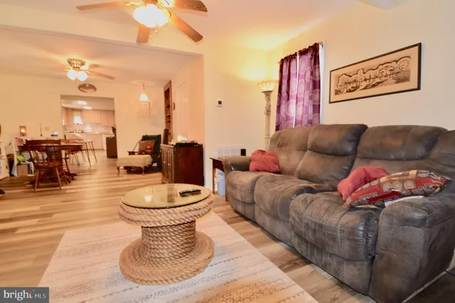 a living room with furniture and a large mirror