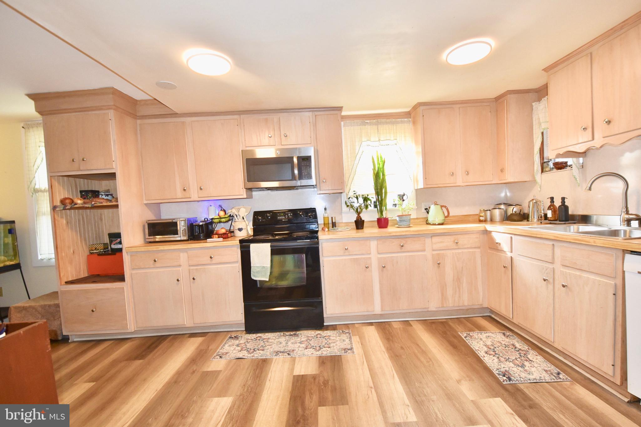 211 Choptank Avenue Cambridge, MD 21613 - Photo 14 of 57 a kitchen with granite countertop white cabinets and white appliances