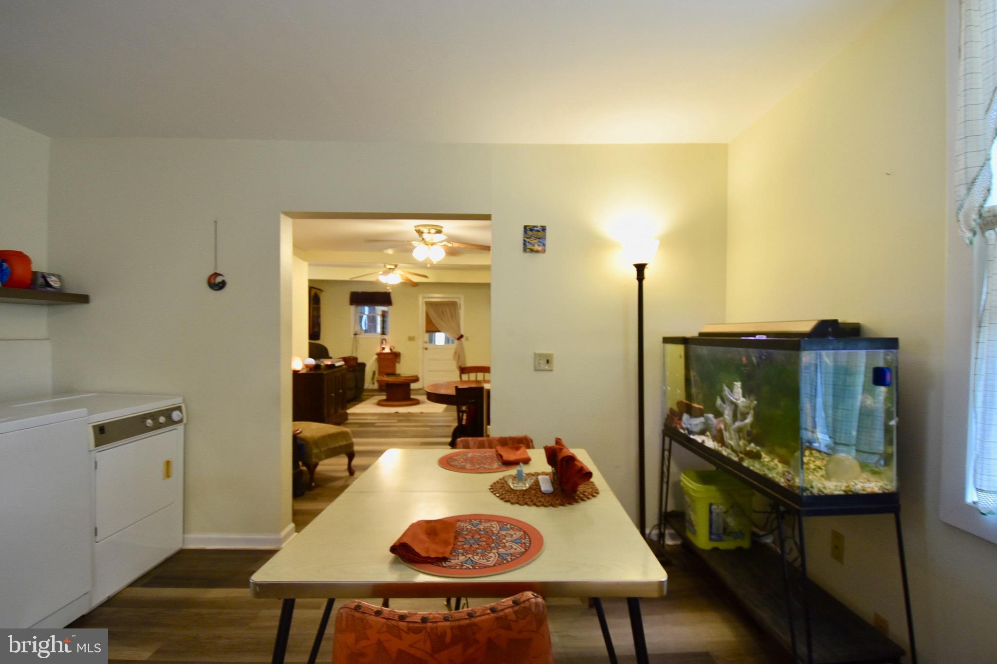 211 Choptank Avenue Cambridge, MD 21613 - Photo 16 of 52 a view of a dining room with furniture and wooden floor