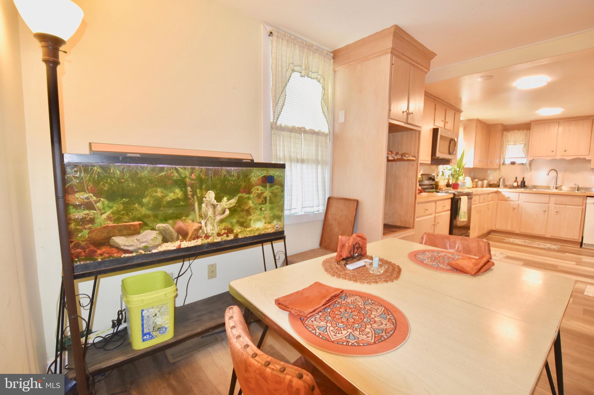 211 Choptank Avenue Cambridge, MD 21613 - Photo 16 of 57 a dining room with a table or chairs and a wooden floor