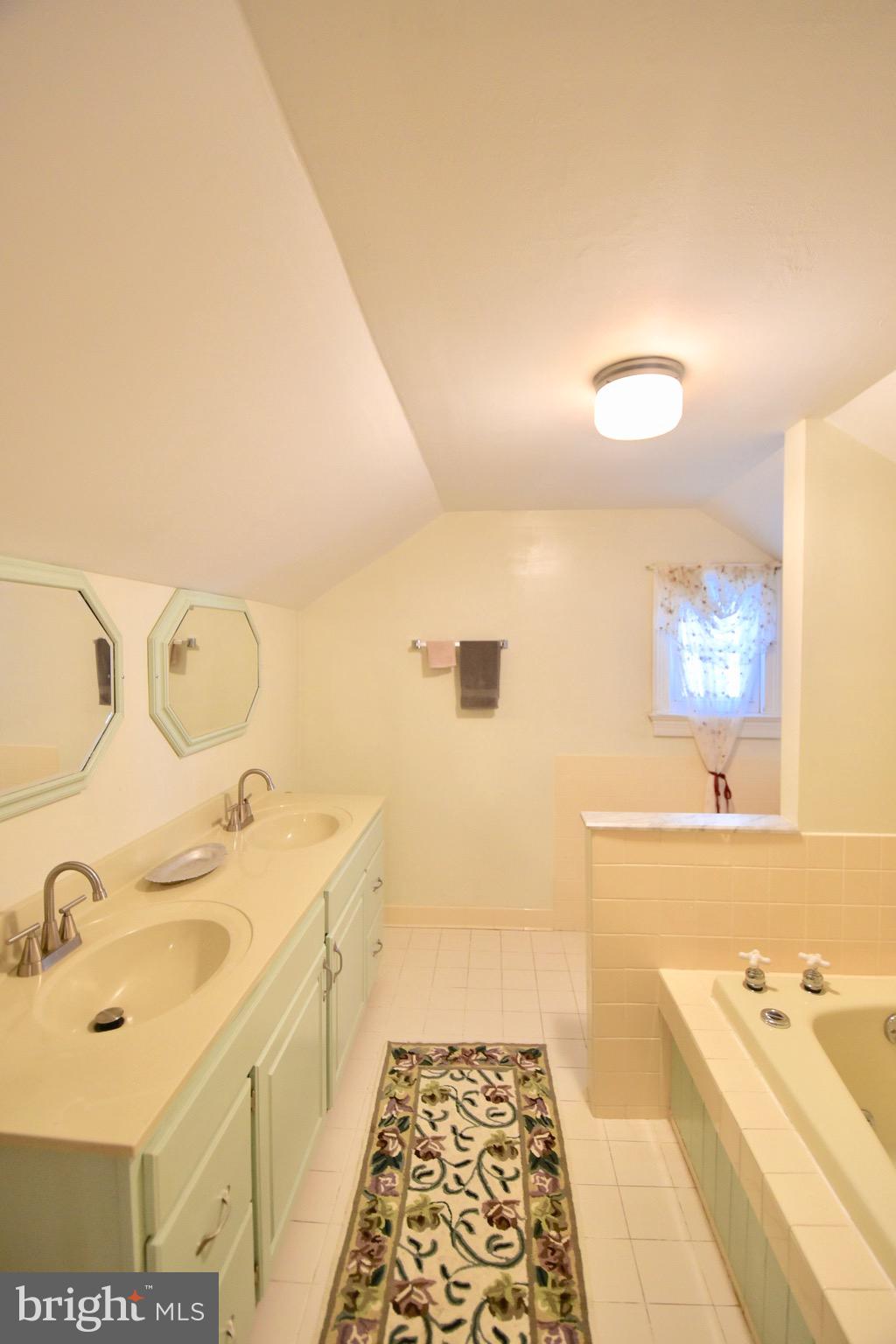 211 Choptank Avenue Cambridge, MD 21613 - Photo 32 of 57 a spacious bathroom with a tub sink and mirror