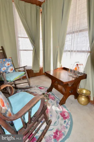 a living room with lots of furniture and a large window