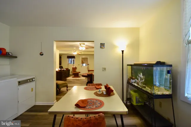 a view of a patio with table and chairs under an umbrella
