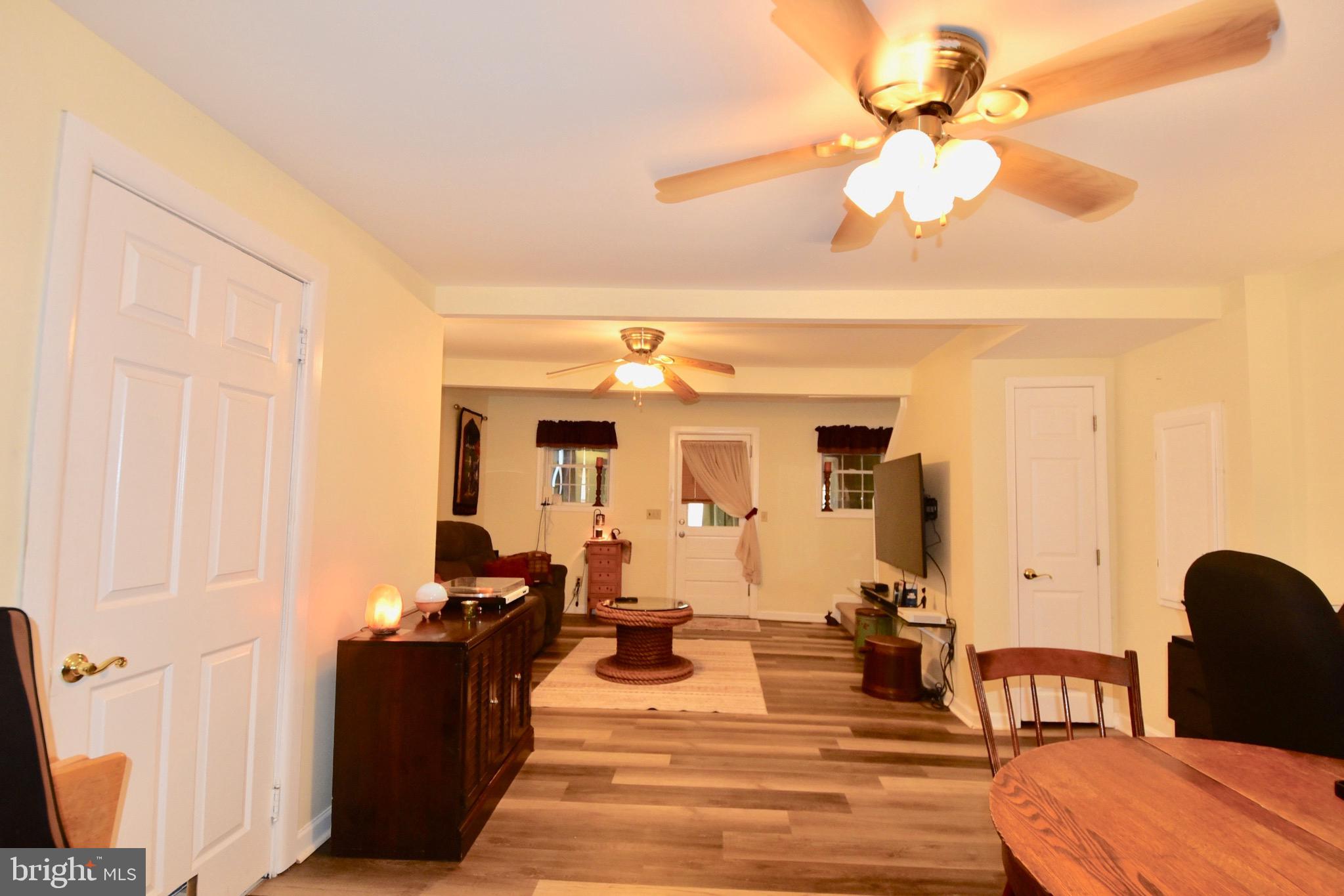 211 Choptank Avenue Cambridge, MD 21613 - Photo 8 of 52 a living room with furniture a chandelier and a dining table