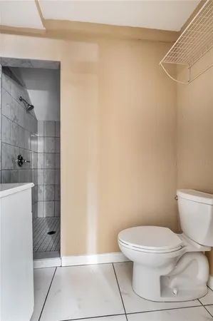 a white toilet sitting next to a bathroom sink and shower