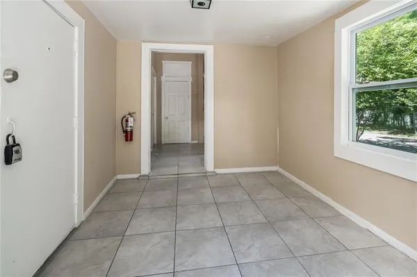 a view of an empty room with a window