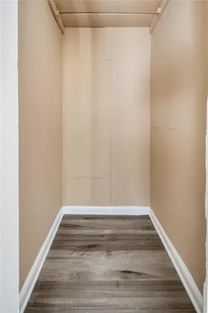 a view of a room with wooden floor