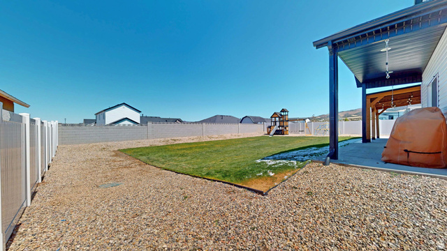 1127 4240 North Enoch, UT 84721 - Photo 54 of 56 Fenced backyard featuring a patio area and a playground