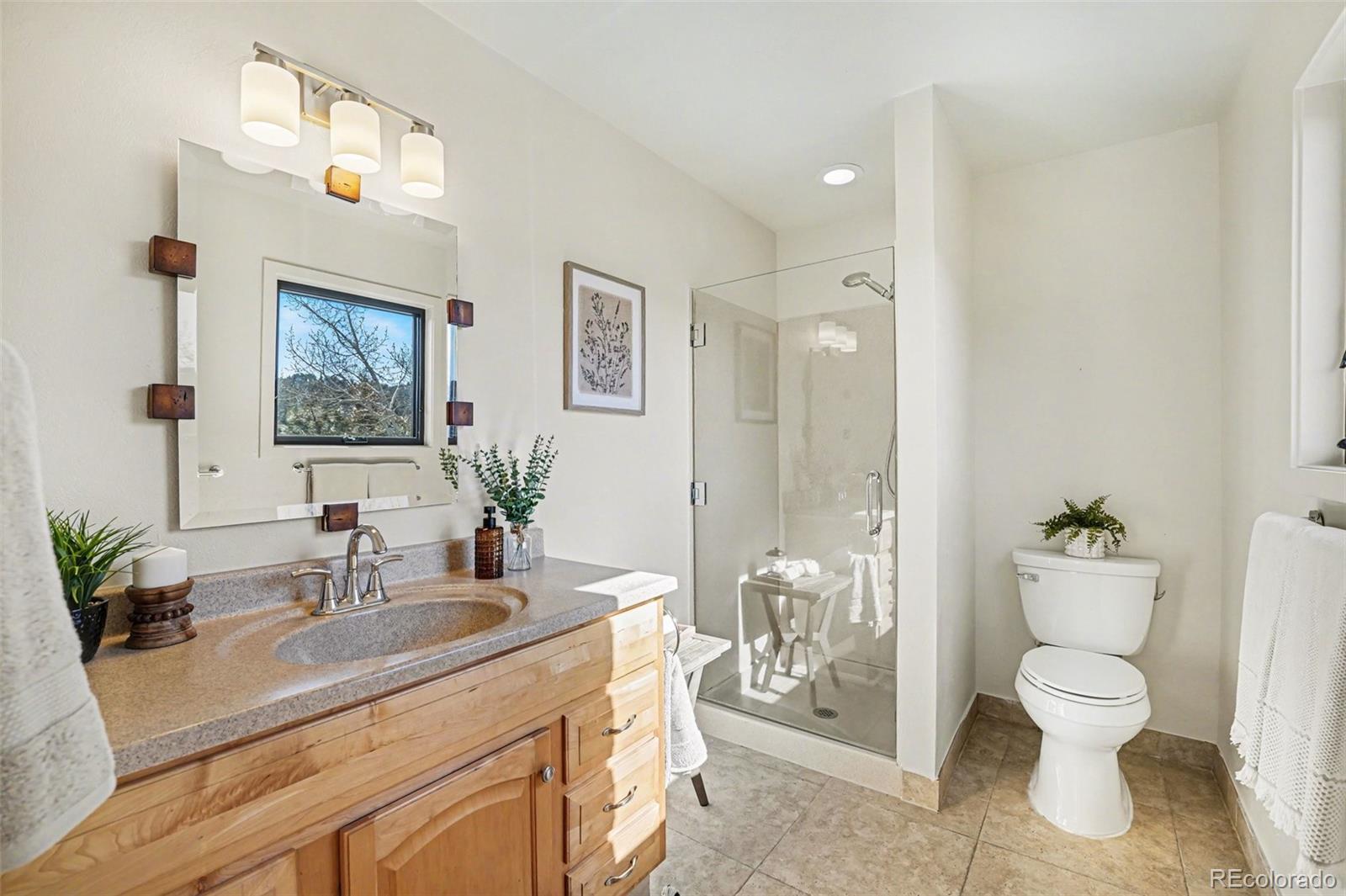 3260 Bit Road Evergreen, CO 80439 - Photo 11 of 26 a bathroom with a toilet sink and mirror