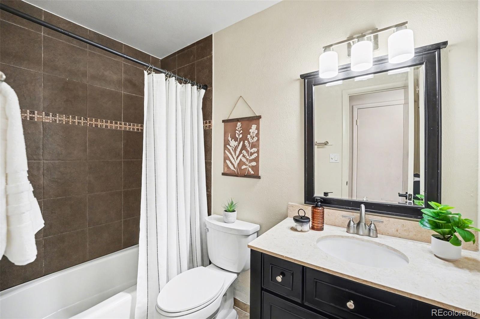 3260 Bit Road Evergreen, CO 80439 - Photo 12 of 26 a bathroom with a sink a toilet and shower