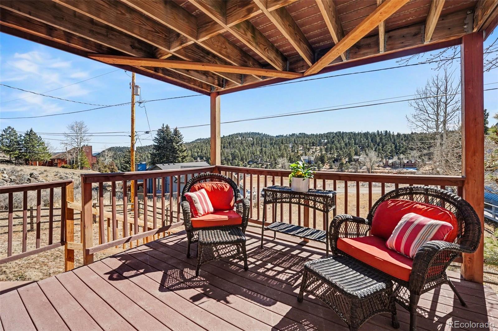 3260 Bit Road Evergreen, CO 80439 - Photo 18 of 26 a view of a chairs in wooden deck