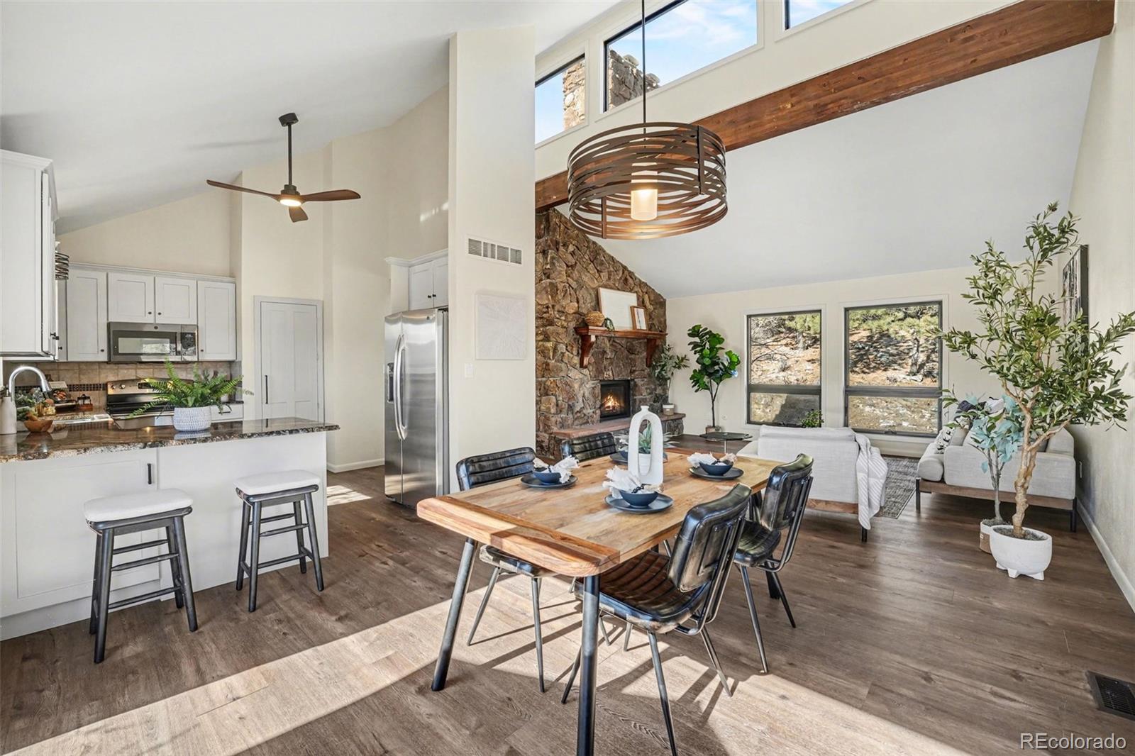 3260 Bit Road Evergreen, CO 80439 - Photo 7 of 26 a view of a dining room with furniture window and wooden floor