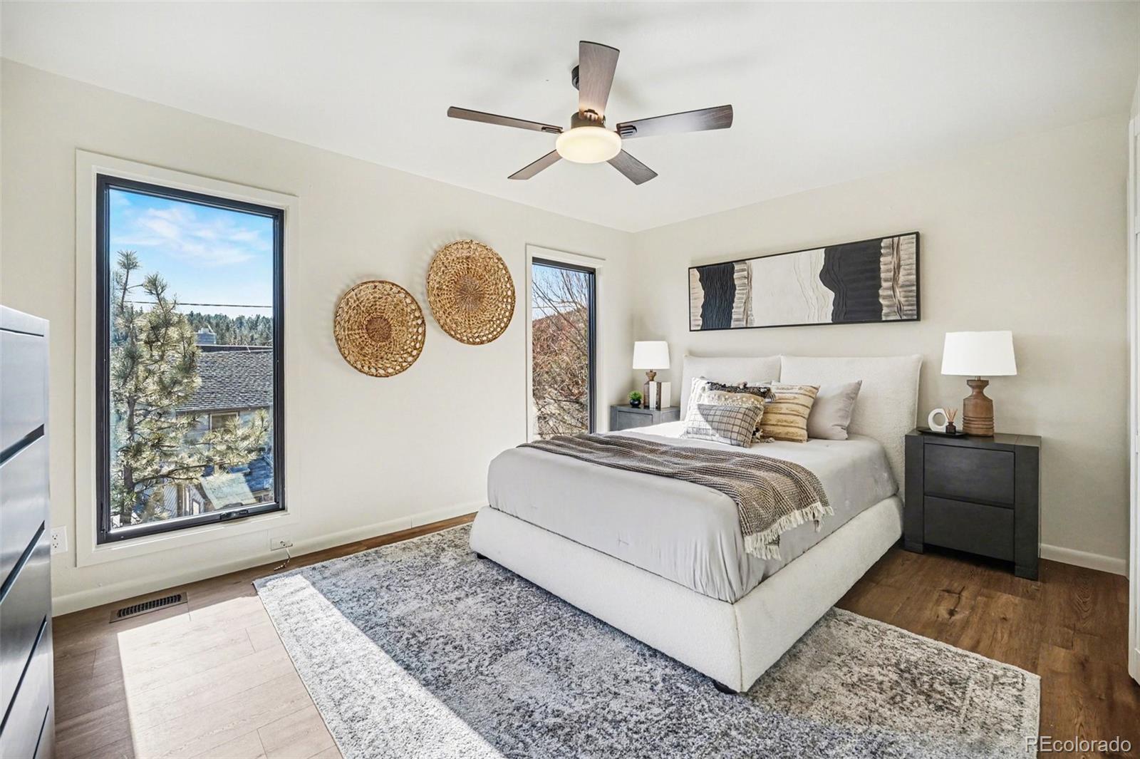 3260 Bit Road Evergreen, CO 80439 - Photo 9 of 26 a bedroom with a bed and painting on the wall