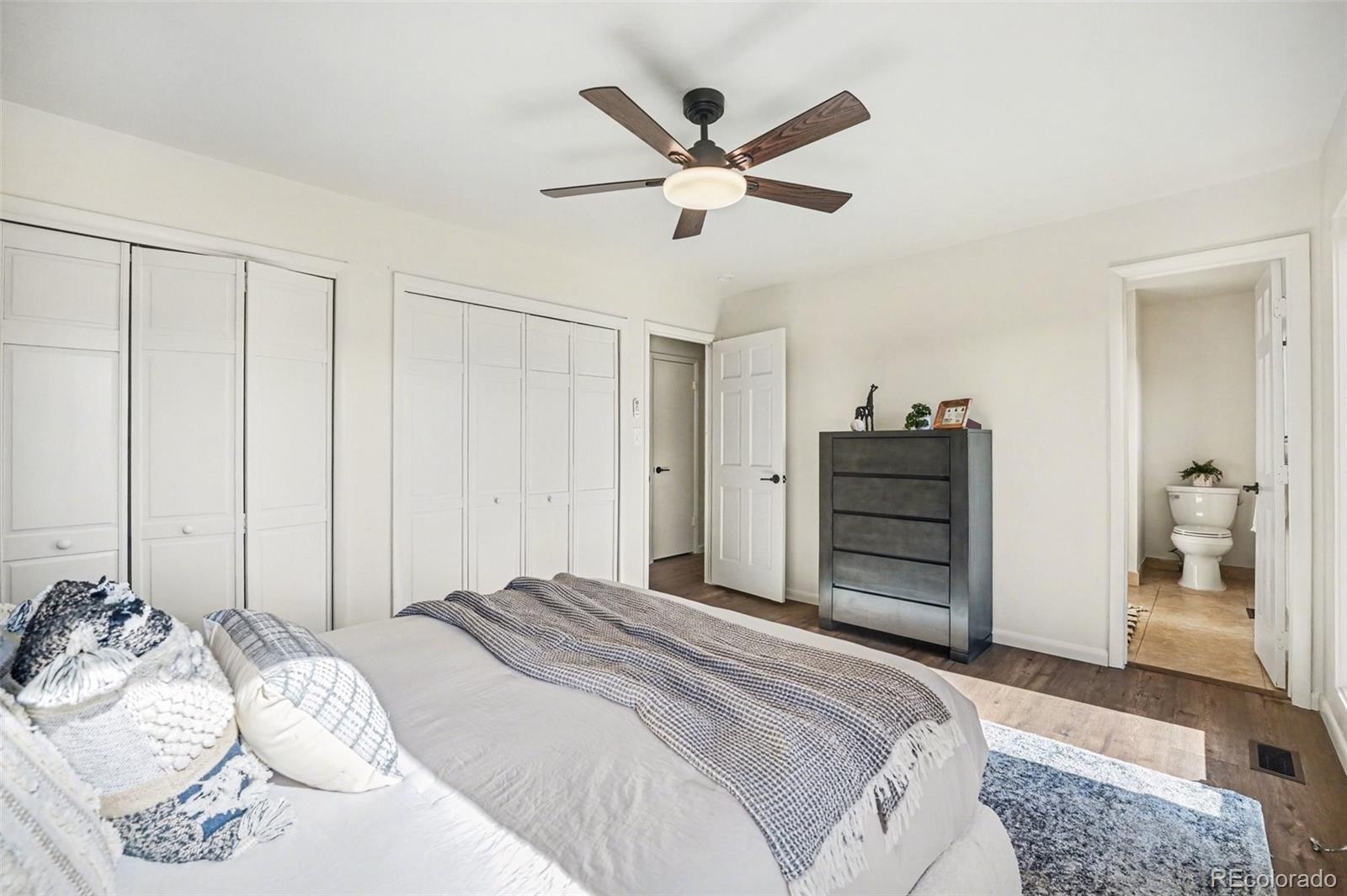 3260 Bit Road Evergreen, CO 80439 - Photo 10 of 26 a bedroom with a large bed and a chandelier