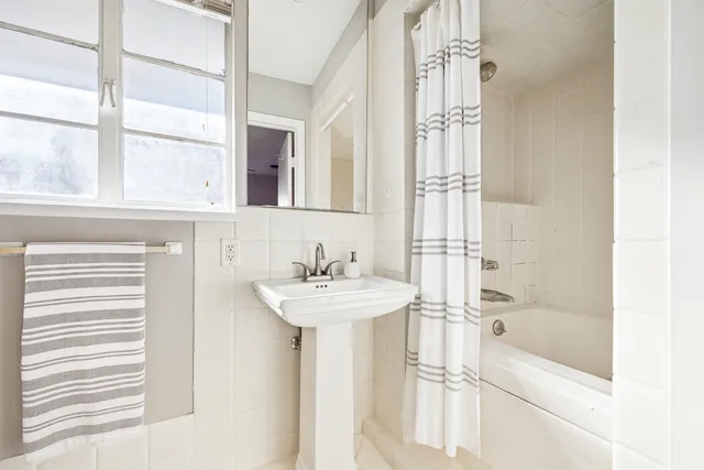 a bathroom with a bathtub and a sink