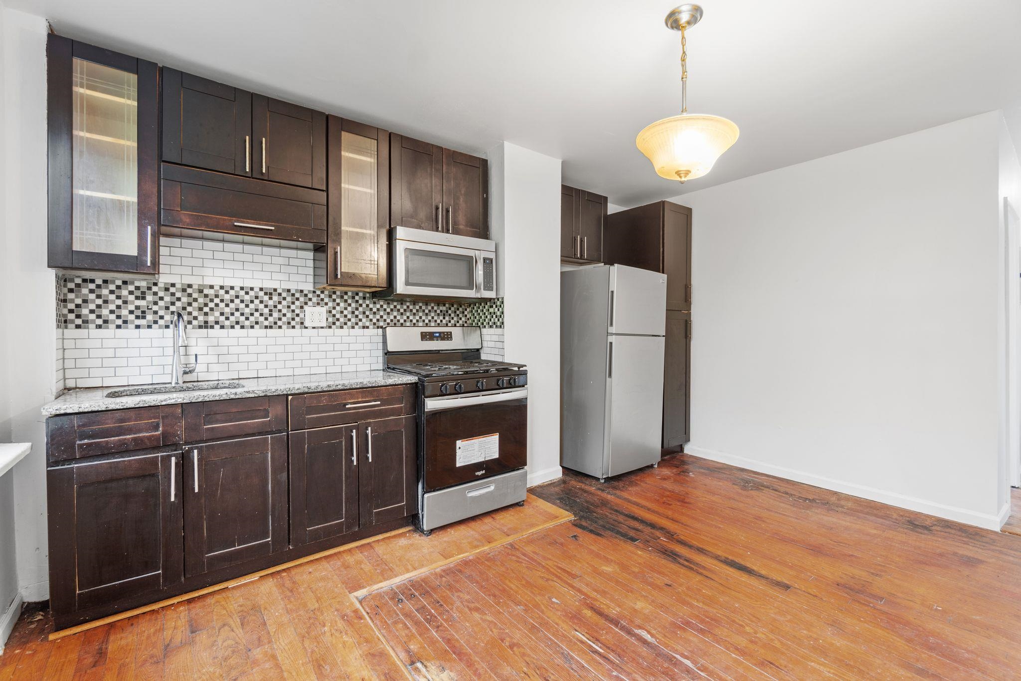 91 Ocean Avenue, Unit 3 Jersey City, NJ 07305 - Photo 2 of 14 a kitchen with stainless steel appliances granite countertop a refrigerator a stove and a sink