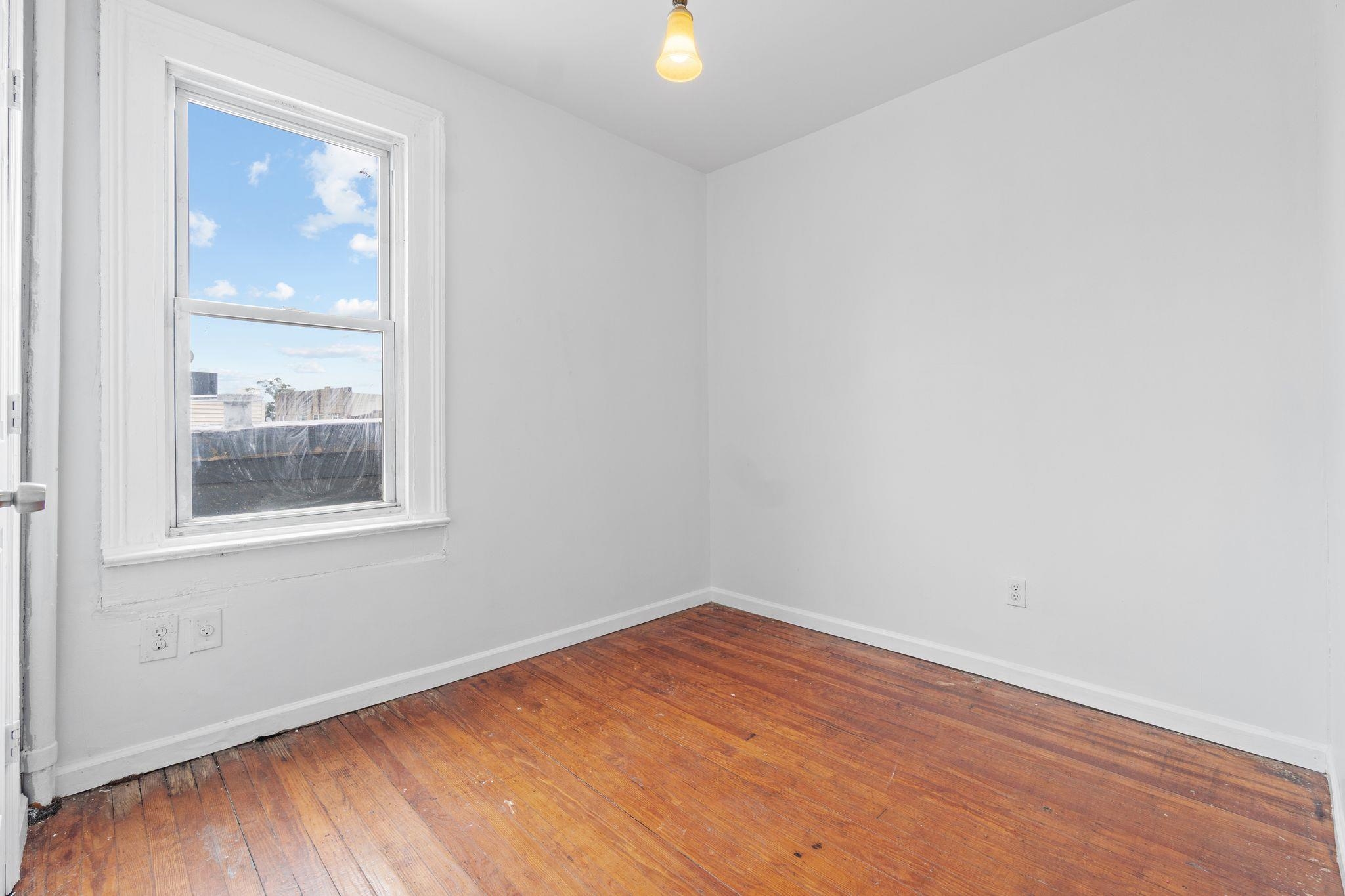 91 Ocean Avenue, Unit 3 Jersey City, NJ 07305 - Photo 4 of 14 an empty room with a window