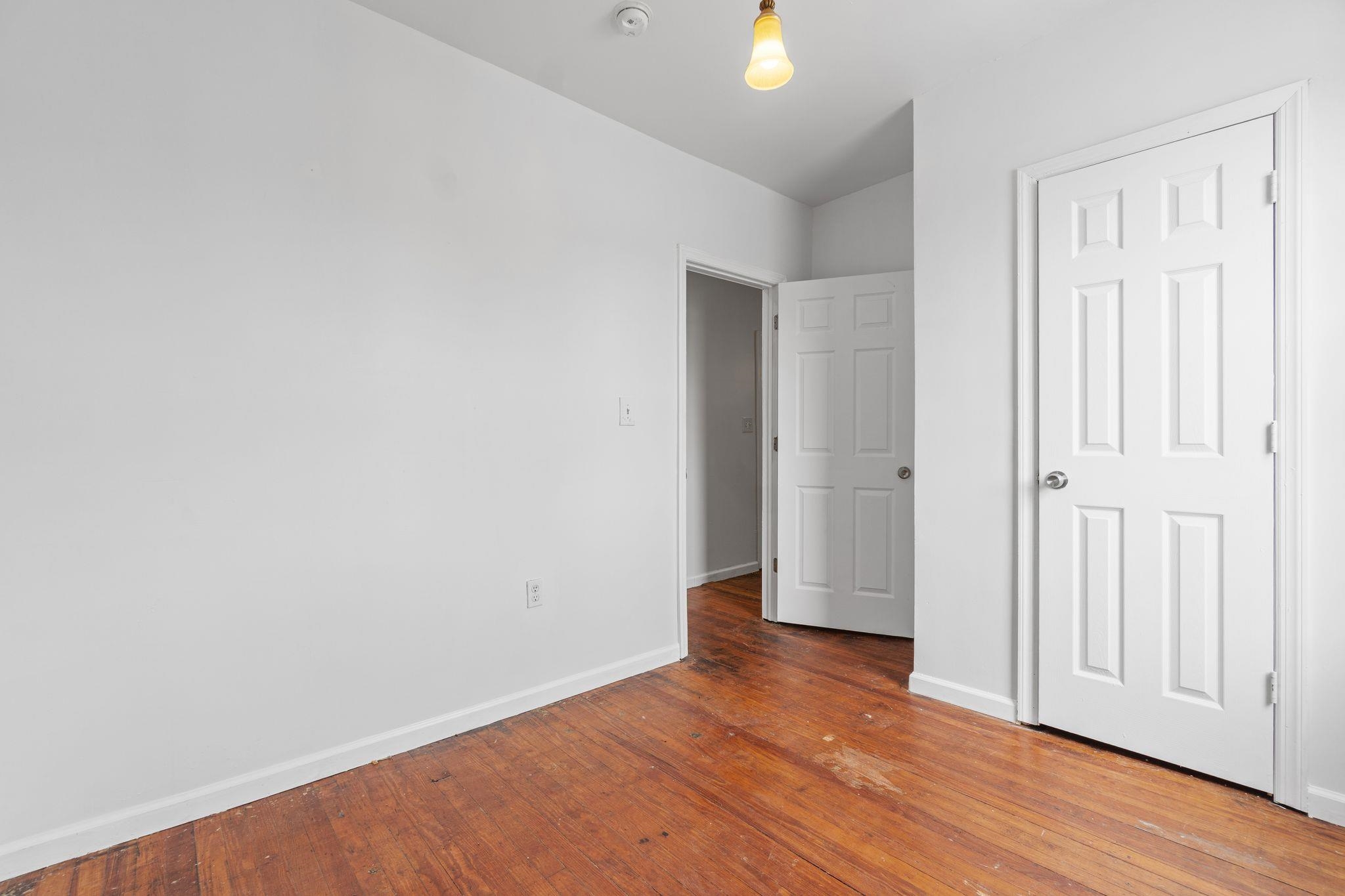 91 Ocean Avenue, Unit 3 Jersey City, NJ 07305 - Photo 5 of 14 an empty room with wooden floor